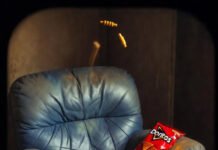 Match Updates Guide: How to Track Every Ball Like a Pro A worn leather recliner buried in Doritos dust, remote lost in the cushions, ghostly cricket stumps floating above an empty Coors Light can and a phone frozen at 247/6, dimly lit and quietly desperate.