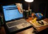 Cricket News Analysis: What Recent Matches Mean for Teams A messy desk at night with an old Dell laptop showing cricket scores, Monster cans, Doritos, and a plastic dinosaur.