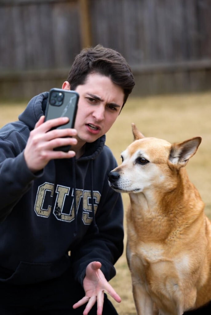 "Awkward selfie: explaining cricket grip in old hoodie to a very uninterested dog"